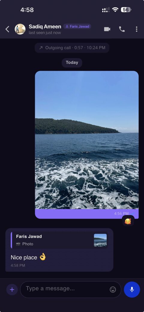 A chat: a sent photo with a heart reaction, and a reply quoting it